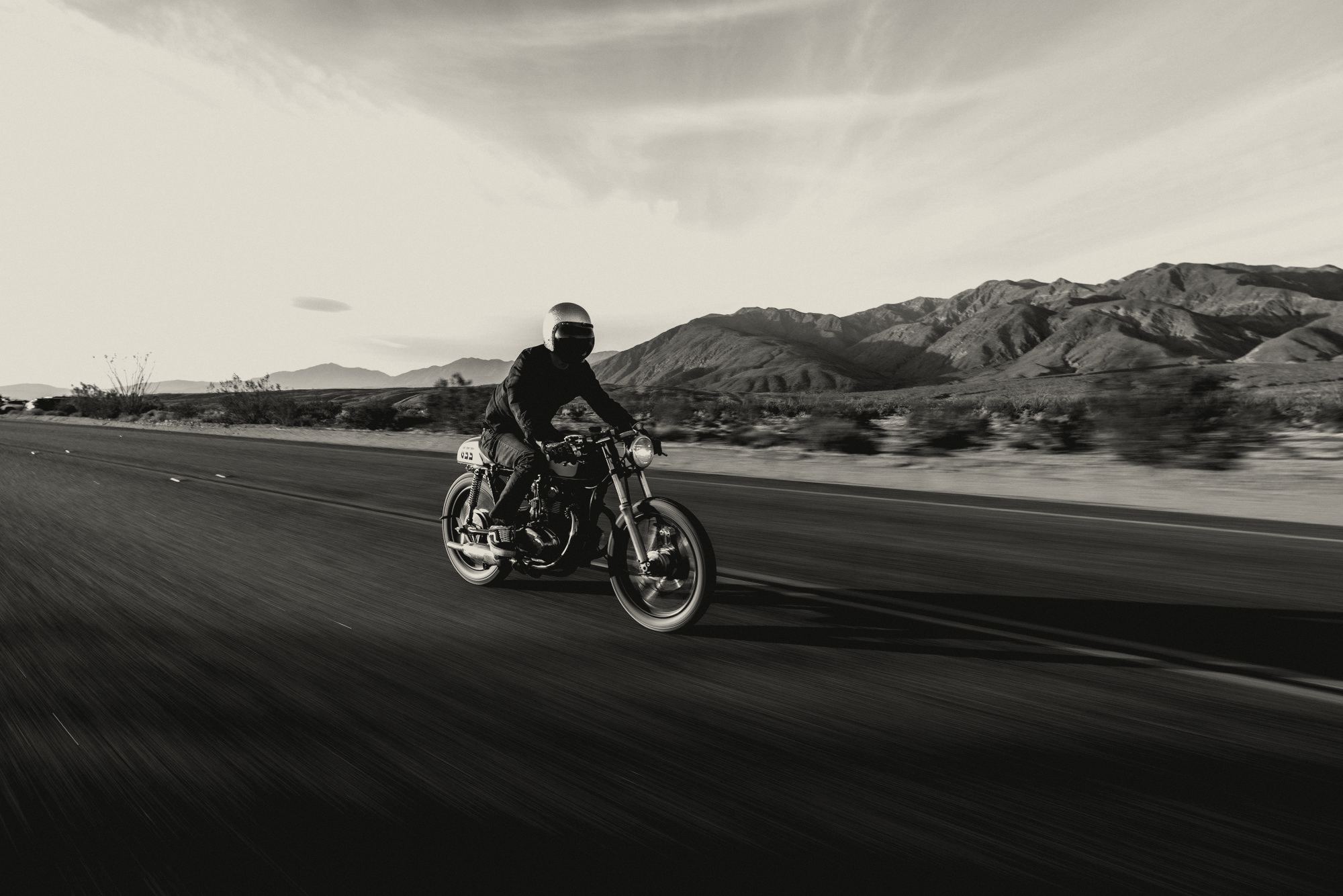 Rider on a classic motorcycle on a desert road