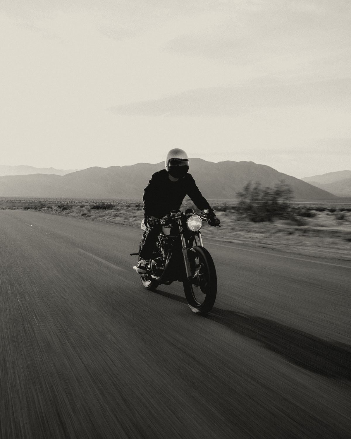 Rider on a classic motorcycle on a desert road