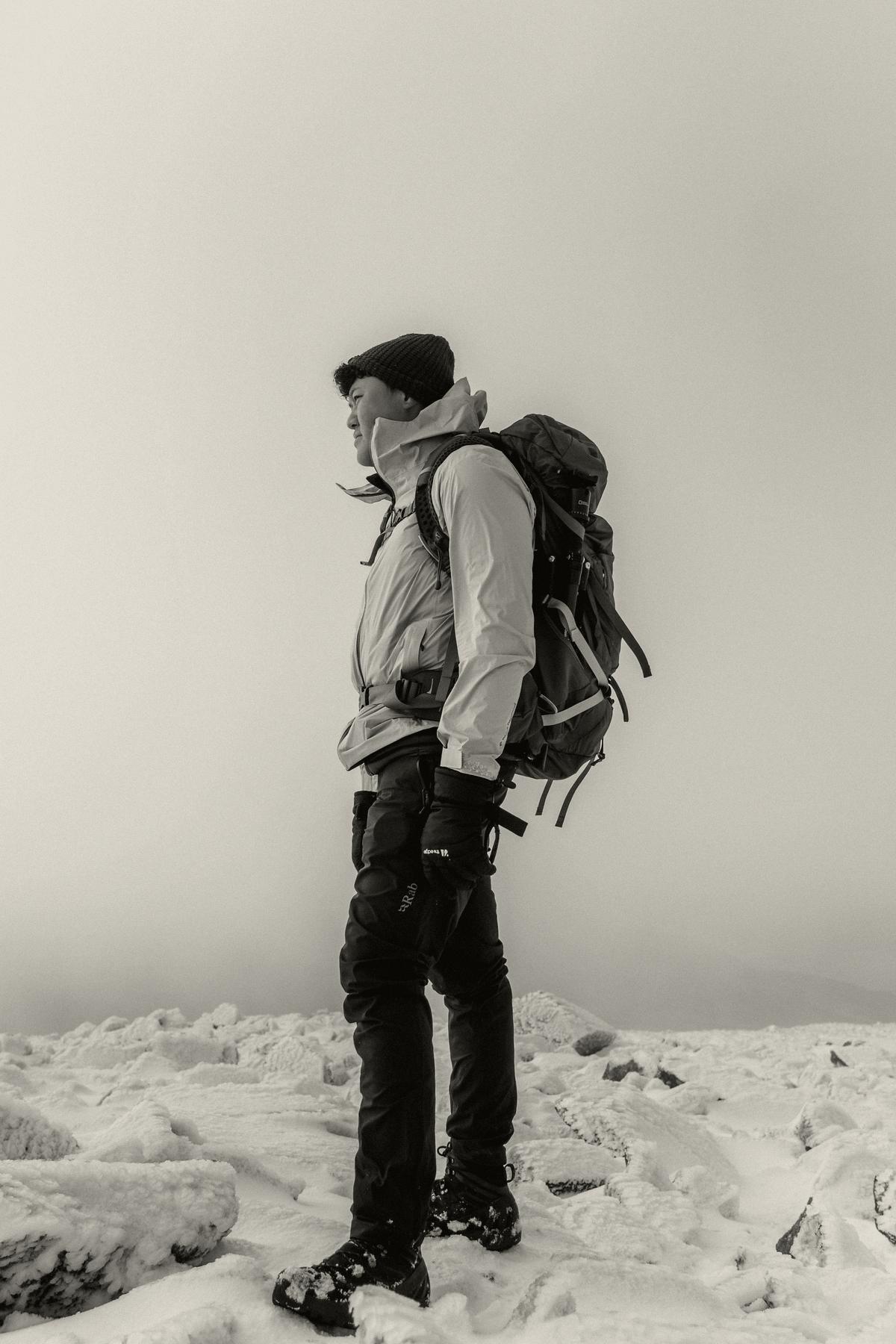 Mountaineer with a pack on a snow ridge