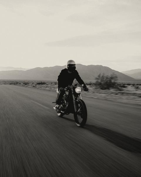 Rider on a classic motorcycle on a desert road