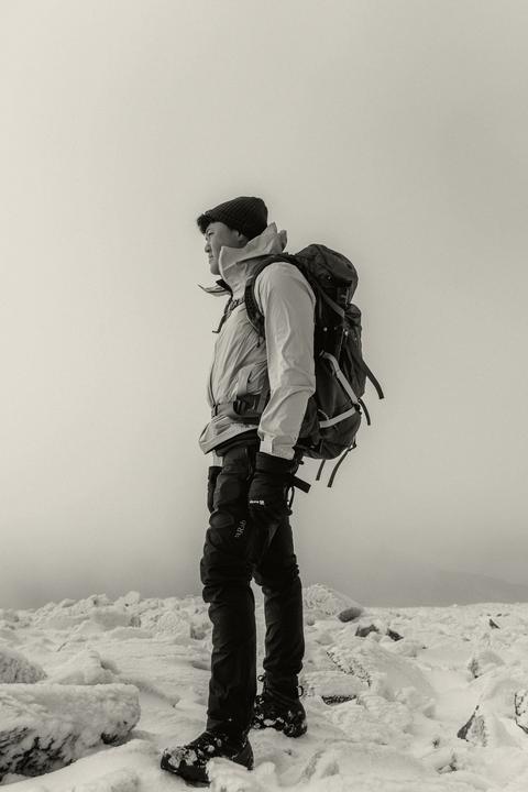 Mountaineer with a pack on a snow ridge